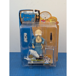 "Front view of a boxed Mezco Family Guy Herbert action figure, showing the full figure and accessories inside the plastic blister on a card with 'Family Guy' logo."