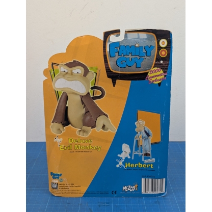 "Angled rear-left view of a boxed Mezco Family Guy Herbert action figure, showing the back of the carded packaging."