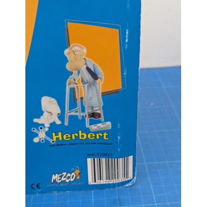 "Angled front-left view of a boxed Mezco Family Guy Herbert action figure, highlighting the side and front of the packaging with the figure visible inside."