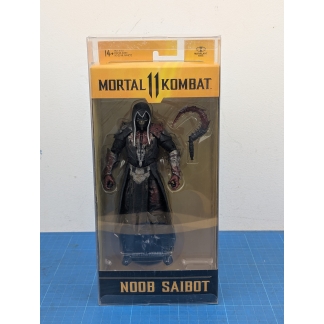 "Front view of a boxed McFarlane Toys Mortal Kombat 11 Noob Saibot action figure, showing the full figure and included weapon inside the clear plastic window.