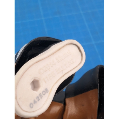 Close-up of the bottom of the foot of a loose WWE Mattel Elite action figure, showing the 'TM & © 2014 WWE Mattel' copyright information."