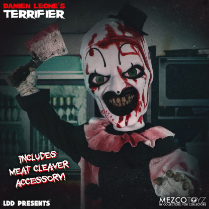A close-up, low-angle shot of the Living Dead Doll of Art the Clown, holding a bloody meat cleaver high in his right hand. His face is heavily splattered with blood, and he has a wide, terrifying grin with prominent green eyes. Text "INCLUDES MEAT CLEAVER ACCESSORY!" is on the left.