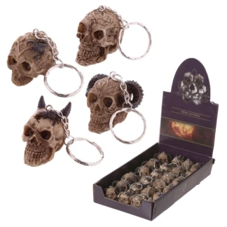 Four Puckator mini carved skull keyrings featuring Celtic knotwork, ram horns, a horned devil, and a scorpion design on a bone-effect finish