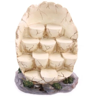 The Puckator Baby Dragon Egg display stand featuring a large cracked stone egg in the center of a rocky, tiered mountain