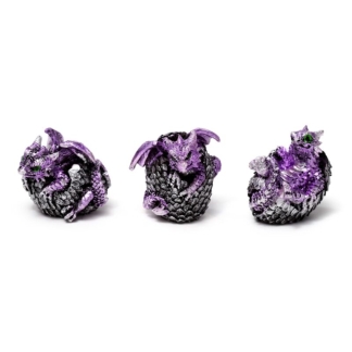 A set of three miniature resin figurines showing baby purple and violet dragons hatching from cracked, bone-colored geode eggs