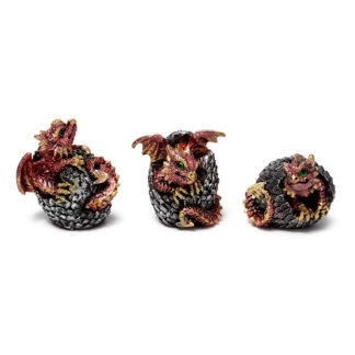 A set of three miniature resin figurines showing baby red and orange dragons hatching from cracked, bone-colored geode eggs.