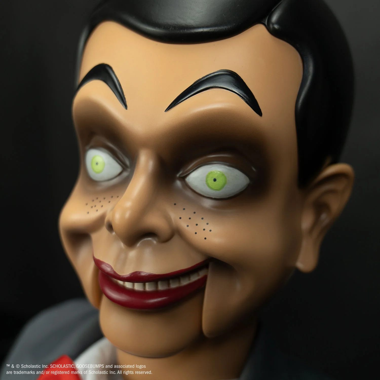 A life-size, 25-inch tall Slappy the ventriloquist dummy wearing his grey suit and red bow tie, standing in a menacing pose