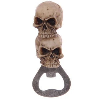 A gothic handheld bottle opener featuring a handle made from two stacked, bone-coloured skulls, terminating in a sturdy silver metal opener hook.