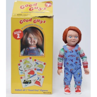 The 'Good Guy' Tommy action figure with a clean, freckled face standing next to its opened yellow Blind Box Series 2 packaging.