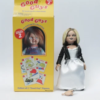 The Tiffany action figure with blonde hair and a white fabric dress standing next to its opened yellow Good Guy Blind Box Series 2 packaging.
