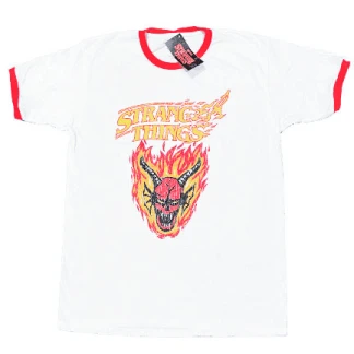 A white ringer t-shirt with a bright red crewneck collar and red sleeve cuffs, featuring a central graphic print of a horned red demon surrounded by yellow flames under the Stranger Things logo