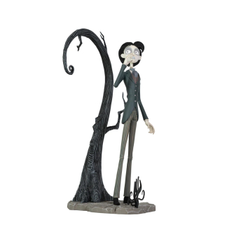 A highly detailed vinyl figurine of Victor Van Dort from Tim Burton's Corpse Bride standing in a black suit on a cobblestone display base with a nervous expression