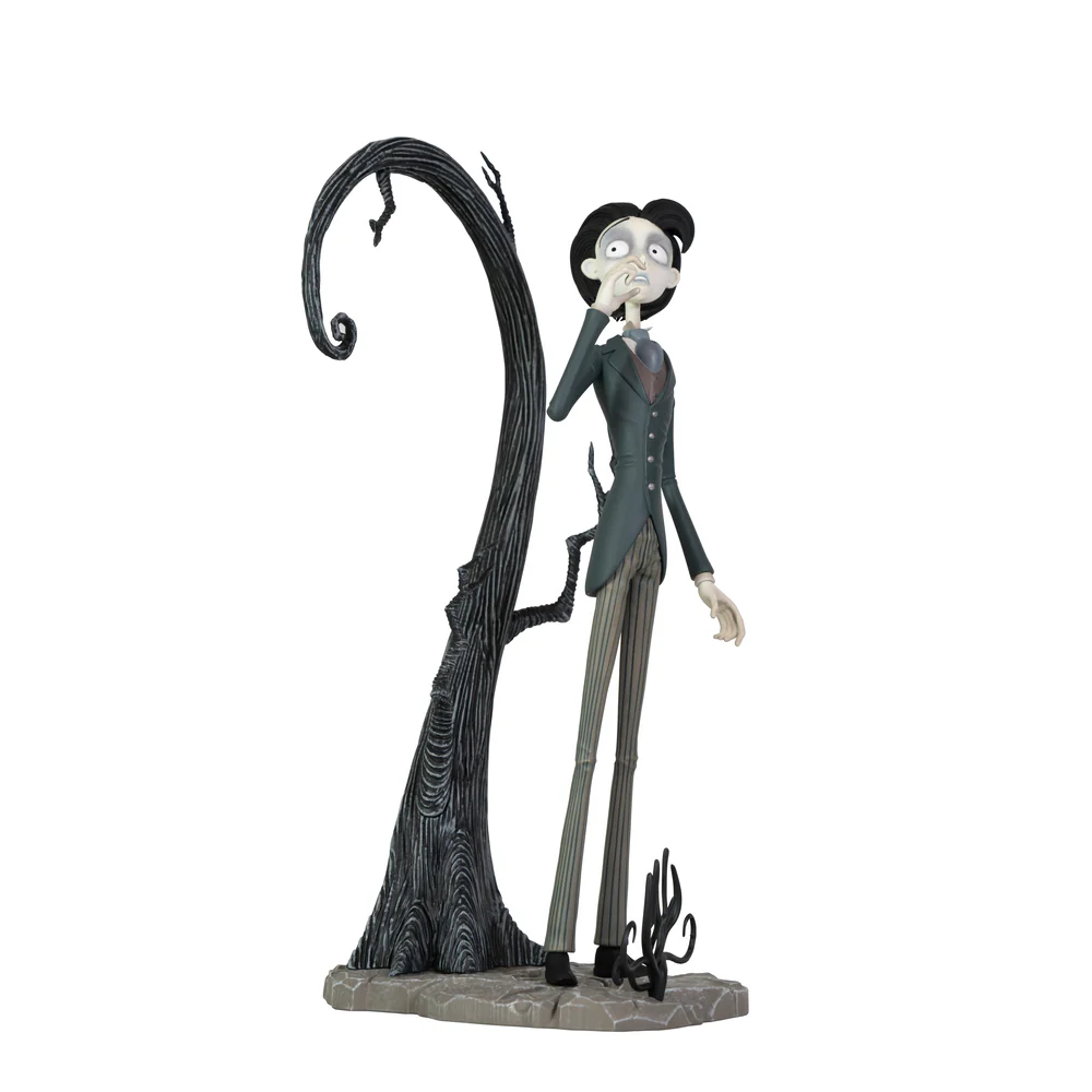 A highly detailed vinyl figurine of Victor Van Dort from Tim Burton's Corpse Bride standing in a black suit on a cobblestone display base with a nervous expression