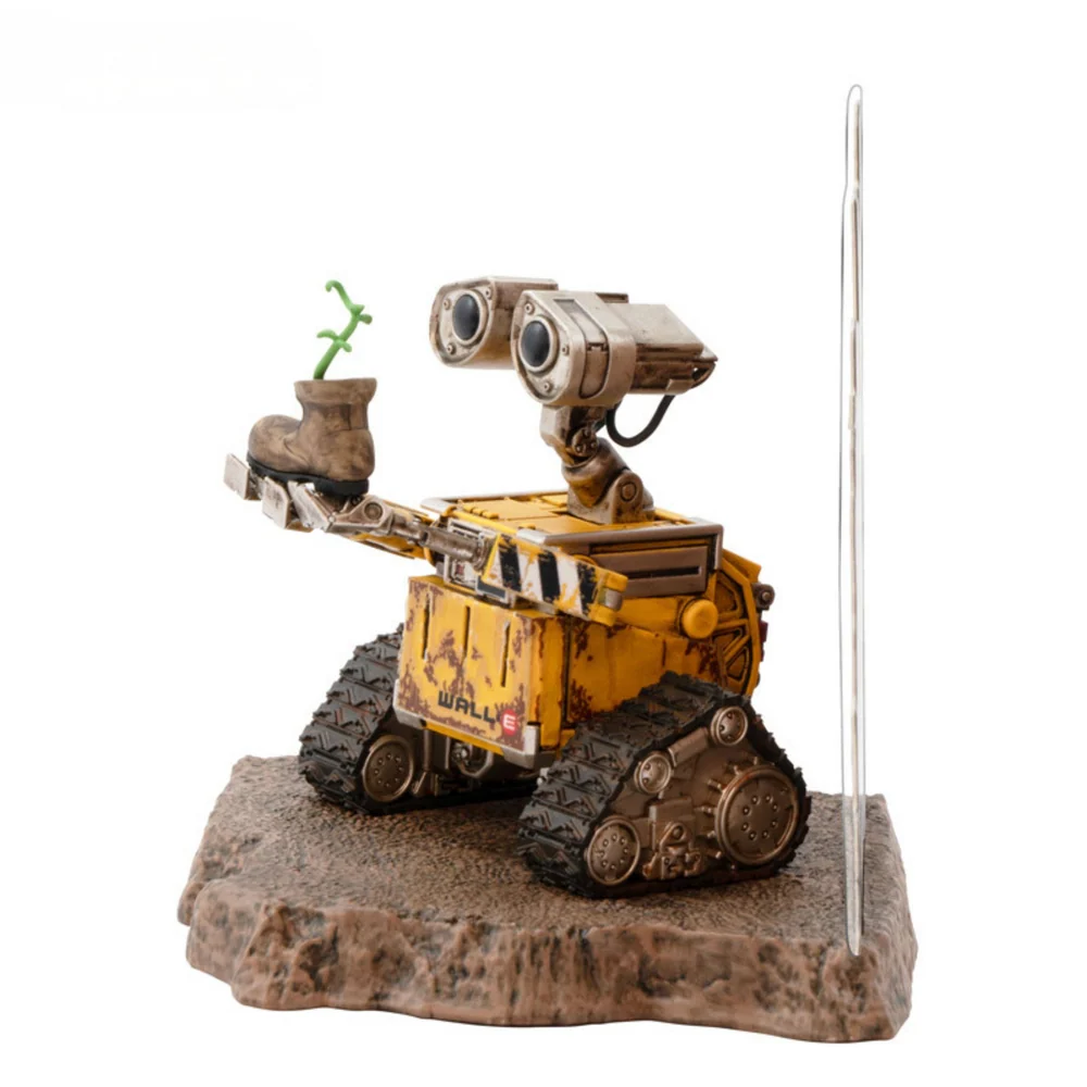 A highly detailed vinyl figurine of Disney Pixar's Wall-E standing on a small trash-heap themed display base, featuring weathered rust details and large expressive eyes